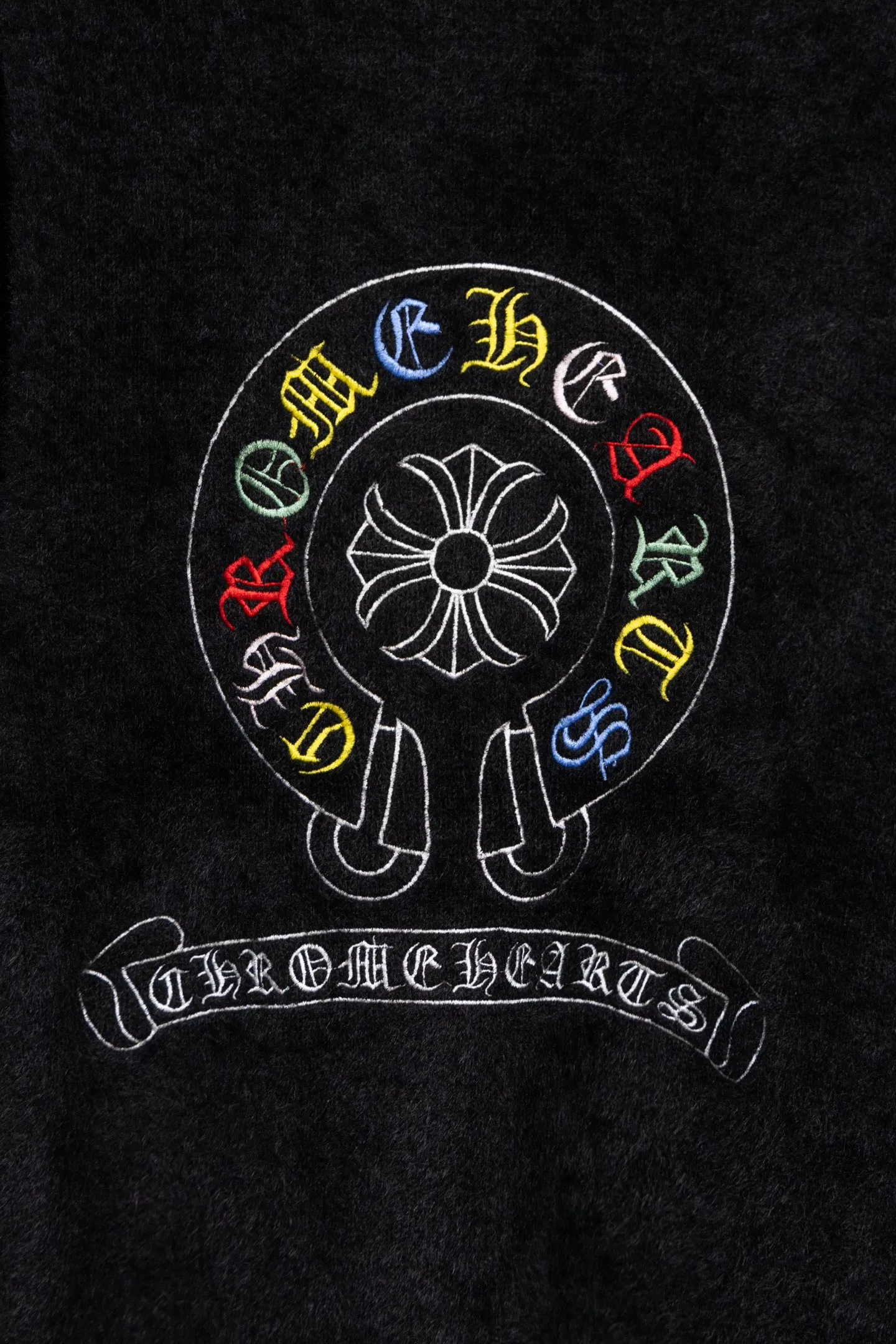 P300 Chrome Hearts CH Chrome Hearts 2026 new cross loose knitted V-neck cardigan Fabric: Made of plush textured knitted material, soft to the touch and with a lazy atmosphere; Decoration: Red, yellow, and black cross ornaments on the chest, paired with brand logo patches, which are iconic elements of street fashion brands (such as Chrome Hearts style), enhancing visual recognition; Version: Loose version + single-row metal button design, combining casual feeling and practicality. 2. Style and Adaptation Style: It combines dark street style and gentle knitted texture, which belongs to the tone of "sweet and cool mix"; Scenario: Can be worn with a T-shirt/suspender to create a daily street look, or can be layered with a shirt for light casual wear. Color: Black White Size: M L XL